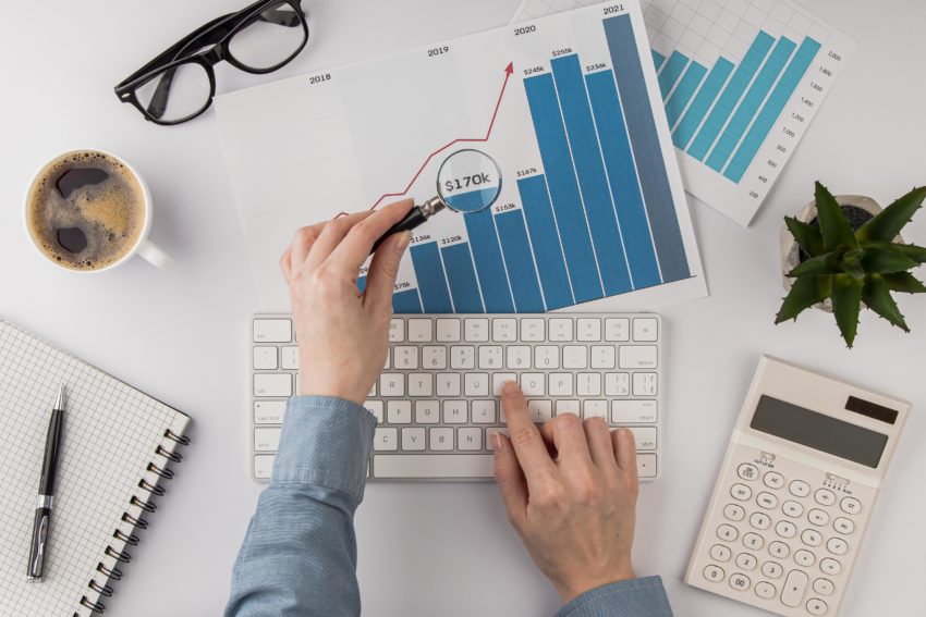 top-view-office-desk-with-growth-chart