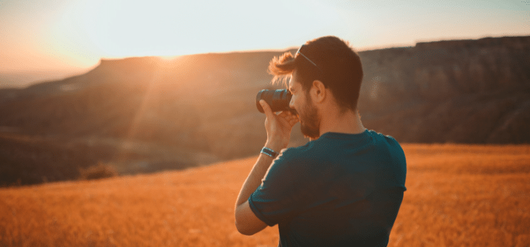 Man taking photo of sunset