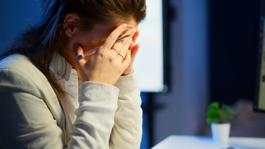 stressed woman looking at spreadsheets