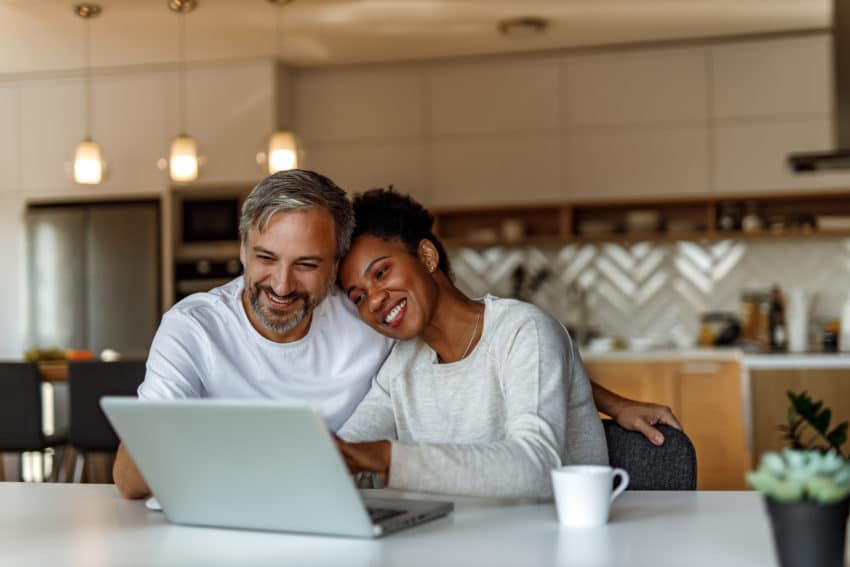 happy couple looking at computer screen