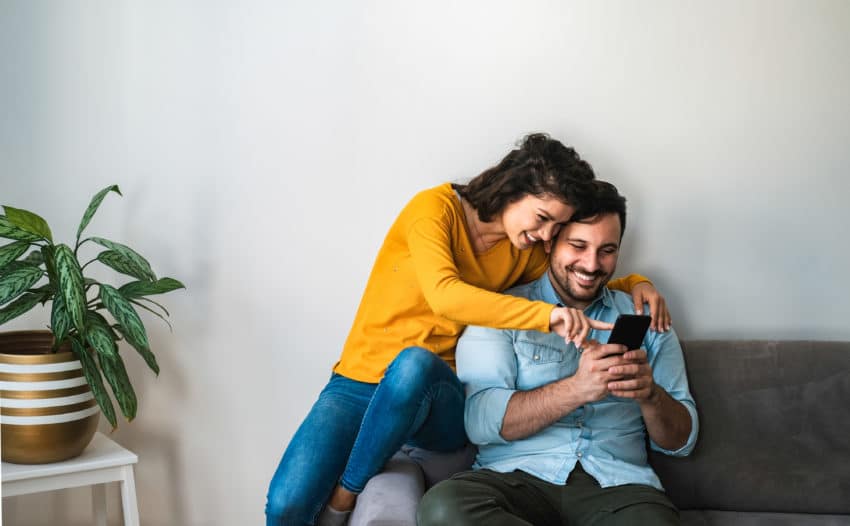 Couple using phone together