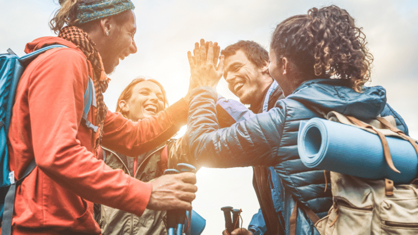 Hikers high fiving each other