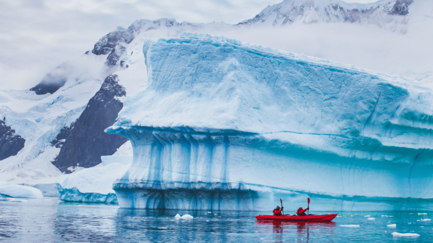 travel business development people kayaking around glacier