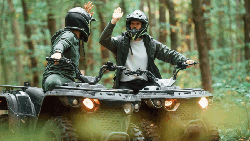 high five between two guys in ATVs